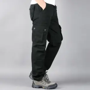 A person standing wearing Men's Military Tactical Pants Cotton Work Overalls Cargo Loose Straight Gym Running Training Sports Wear Jogger Sweatpants and gray hiking boots.